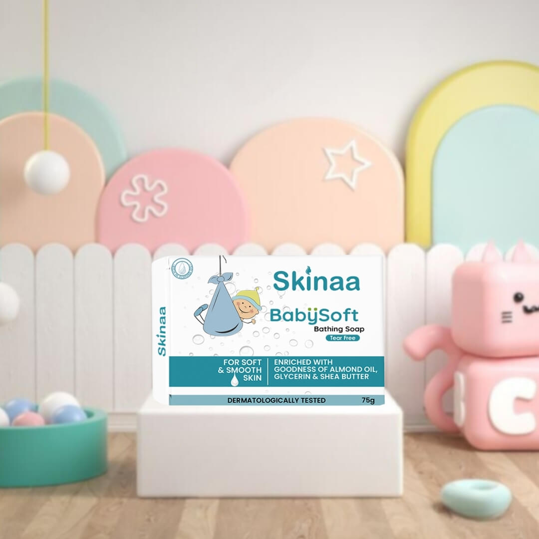 Skinaa BabySoft Bathing Soap 75g pack, enriched with coconut oil, almond oil, glycerin, and shea butter, placed in a pastel nursery-themed setup with toys and baby decor in the background